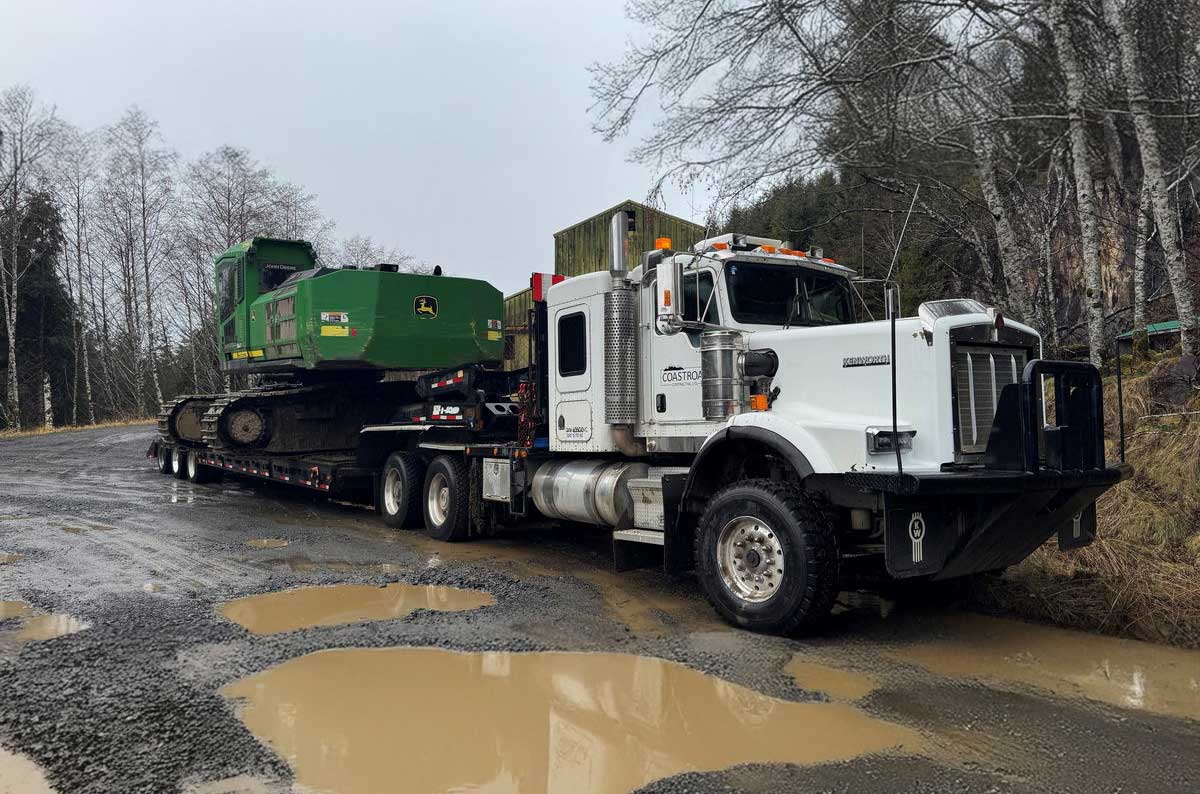 Lowbed Truck transporting heavy machinery on trailer