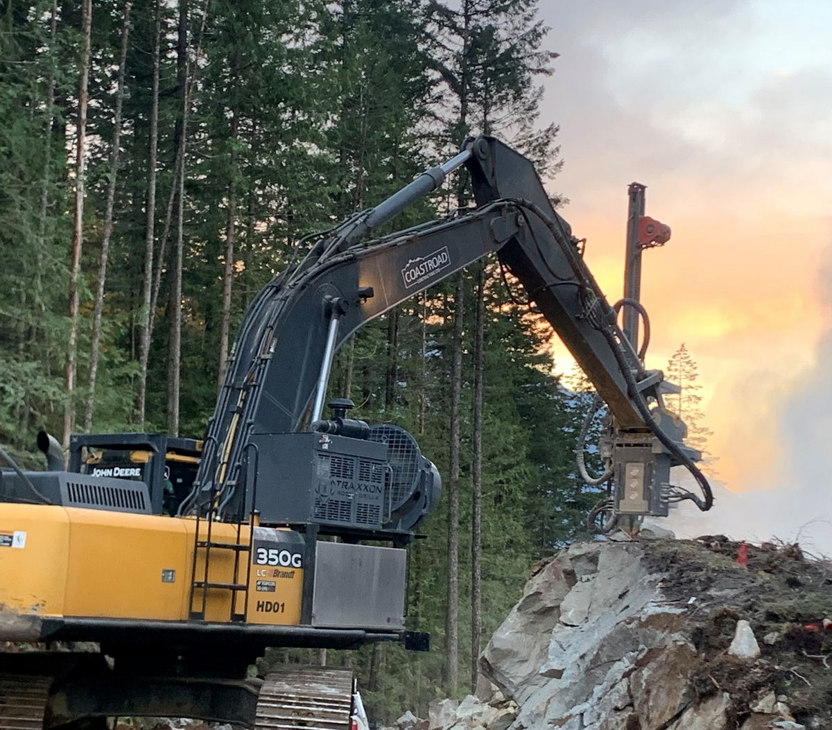 Excavator working on rocky terrain.